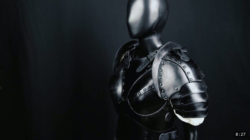 the finished black leather Warrior female breastplate worn on a mannequin, with a shoulder pauldron in place
