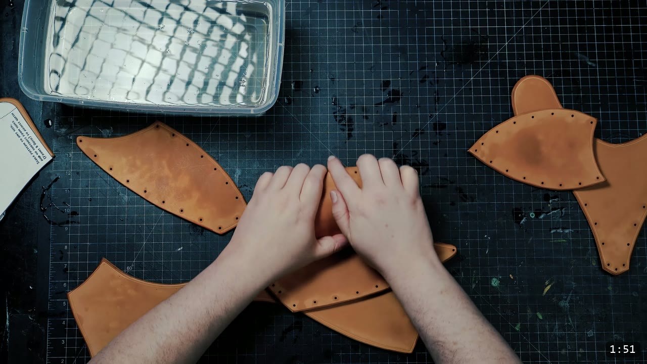 Female Leather Breastplate Build Guide: Warrior Armor from Cups to Buckles 4 shaping a damp tan leather cup piece by hand over a cutting mat with a tub of water nearby