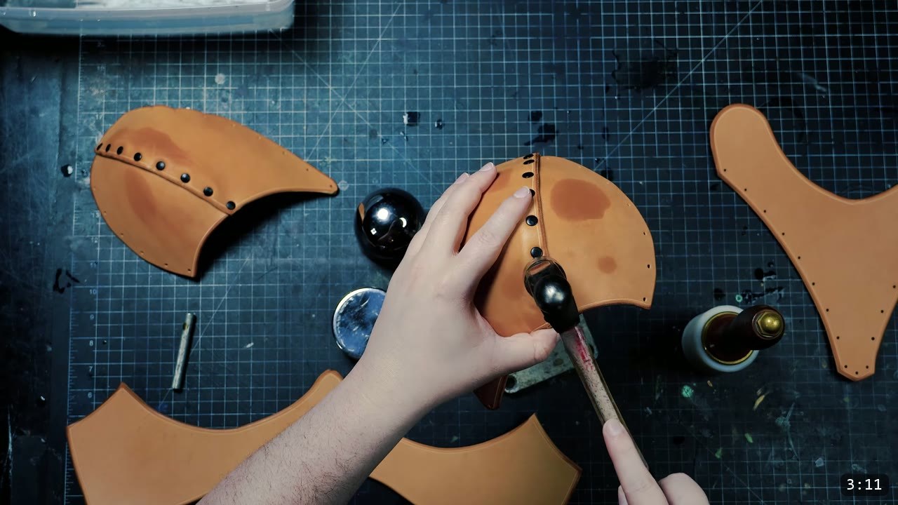 Female Leather Breastplate Build Guide: Warrior Armor from Cups to Buckles 7 hammering a rivet on a tan cup and torso assembly held over a round steel form, a dye bottle to the side