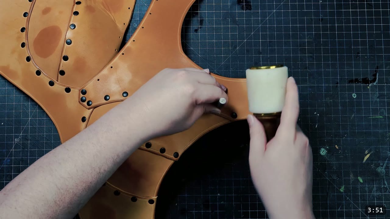Female Leather Breastplate Build Guide: Warrior Armor from Cups to Buckles 8 setting a rivet with a rivet setter and mallet on the tan front torso with both cups attached and the shaped waist