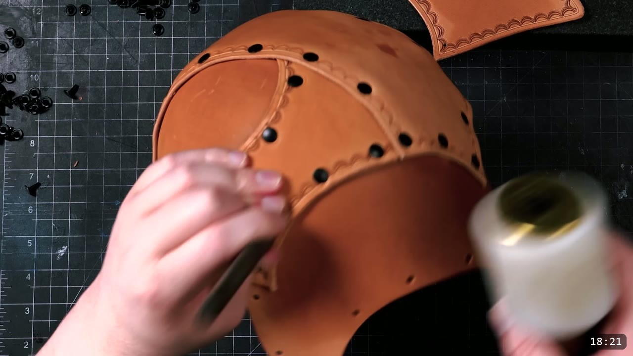 Leather Warrior Helmet Build Guide: Flat Pattern to Finished Piece 11 a well-formed tan dome with many black rivets and stamped seams, a hand seating a panel with a white mallet