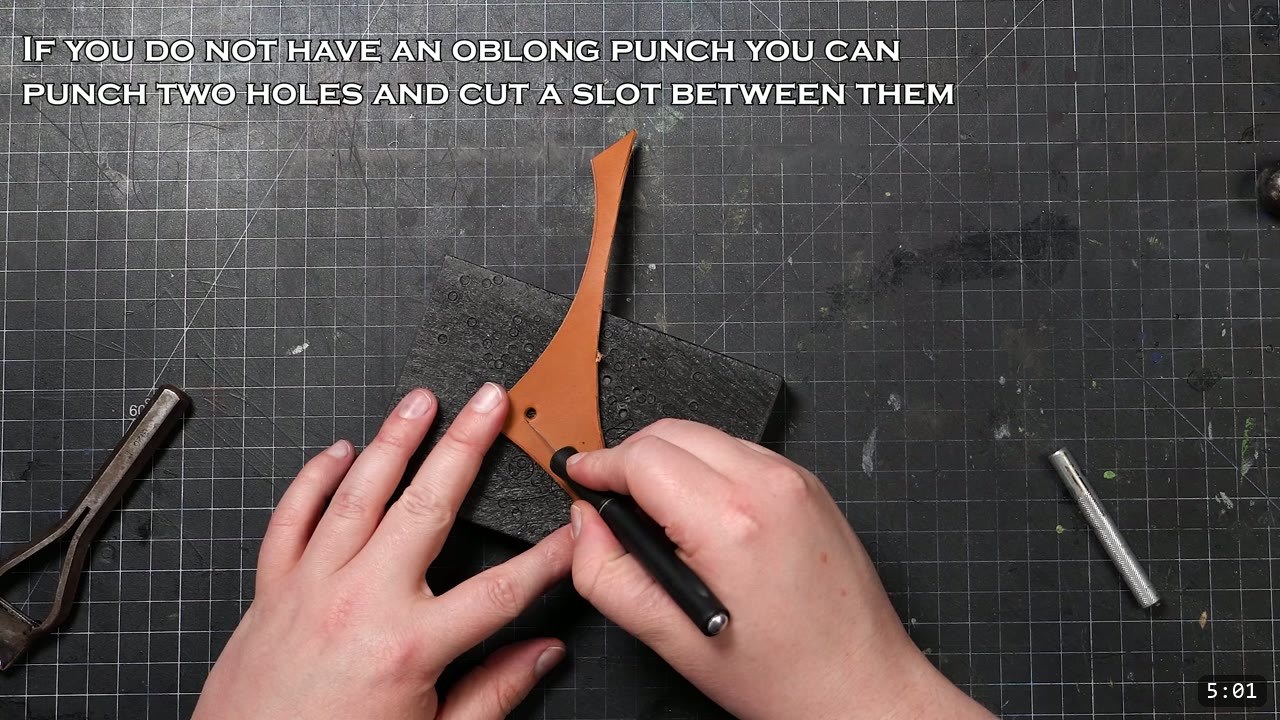 DIY Leather Pauldrons: A Beginner Build for Warrior Shoulder Armor 11 punching the pass-through slot in the tan guard piece on a poly board, with an on-screen note about cutting a slot between two holes