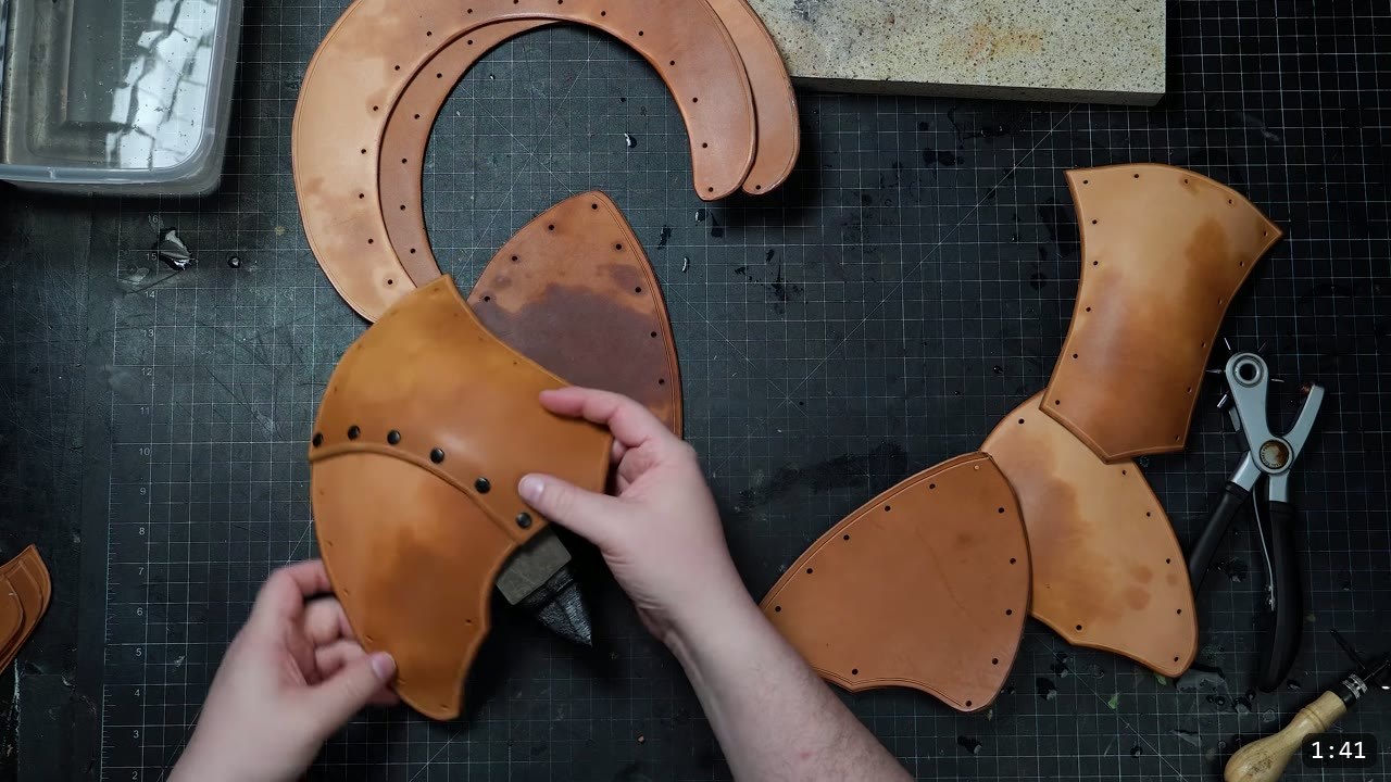 DIY Leather Pauldrons: A Beginner Build for Warrior Shoulder Armor 5 the domed shoulder pieces riveted together with black double-cap rivets, with punched pieces and a rotary punch waiting to the right