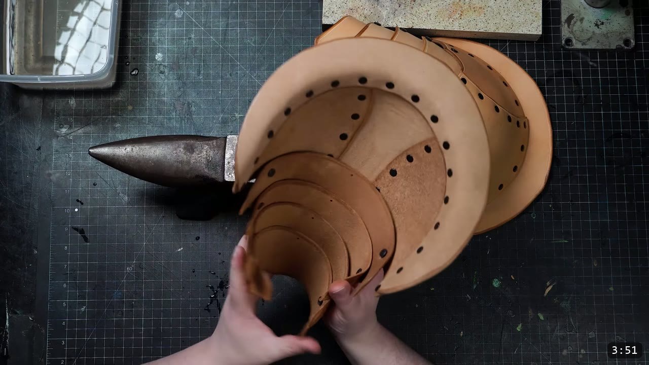 DIY Leather Pauldrons: A Beginner Build for Warrior Shoulder Armor 8 the articulated pauldron with its overlapping lames fanned open, held over the bench beside a steel stake