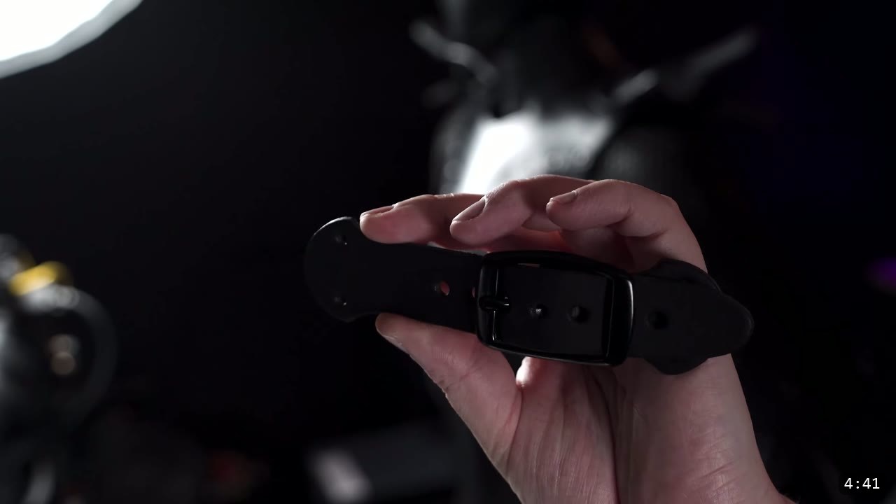 DIY Leather Pauldrons: A Beginner Build for Warrior Shoulder Armor 10 a black leather buckle strap with a wide tab base and a black roller buckle, held up to the camera
